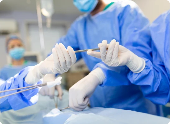 Surgeons performing an operation and passing surgical instruments.